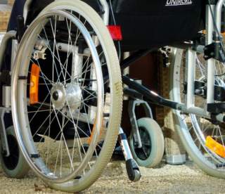 photo of closeup of a wheelchair wheel and brake