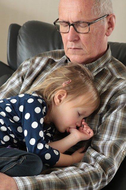 grandfather holding sleeping baby