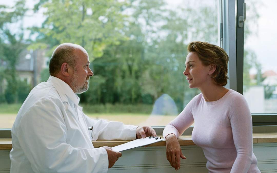 photo of a healthcare practitioner speaking with a woman