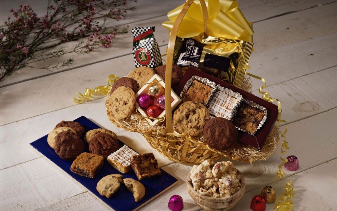 Gift basket overflowing with decadent chocolates and treats, adorned with a gold bow.